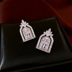 Vintage silver-plated drop earrings with white zircon inlays on a black leather jewelry box
