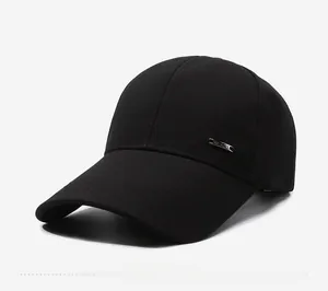 Detailed close-up of a black baseball cap with a silver metal badge on the side panel