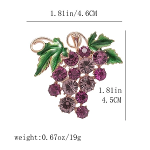 Detail view of grape brooch with purple rhinestones and green enamel leaf showing dimensions