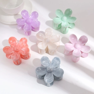 Detailed top view of six colorful flower hair claws in elegant pastel gradient shades
