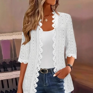 Detail of elegant white eyelet embroidery and lace texture on a short sleeve cardigan