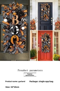 Detailed view of Halloween BOO wreath with orange black ribbons and spiders on the door