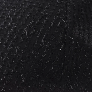 Dettaglio macro di tessuto nero di alta qualità con fili metallici argentati brillanti