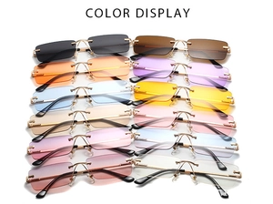 Detailed color display of rimless rectangular sunglasses with gold metal frames and stems