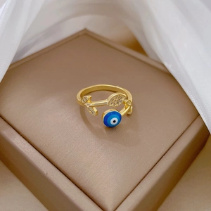 Gold plated ring featuring a blue evil eye and zircon leaves on a jewelry box