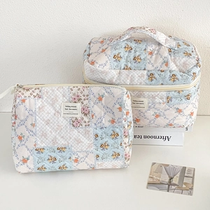 Detailed set of two quilted floral cosmetic bags with vintage patterns and cotton texture