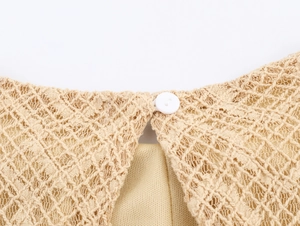 Detailed view of the elegant beige lace dress neck closure with a small round button