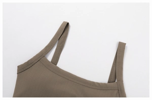 Detail of brown ribbed knit yoga bra with flat neckline and thin double straps