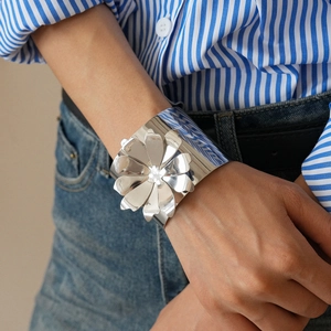 Macro detail of silver oversized flower cuff bracelet with high-polish mirror finish