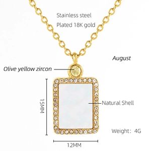 Detail of 18K gold plated stainless steel necklace with olive yellow zircon and shell