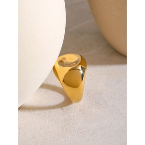 Detail of an 18k gold plated chunky spiral ring with a smooth irregular metallic finish