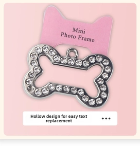 Macro detail of bone-shaped rhinestone pet tag with a mini photo frame hollow design