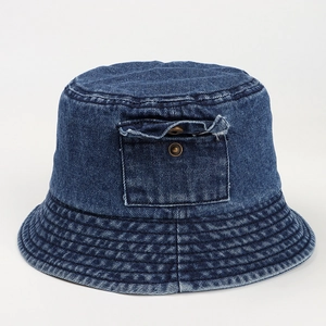 Detail of blue denim bucket hat showing decorative front pocket and metal button