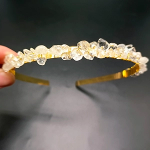 Detail of handmade gold crown headband featuring raw natural clear quartz crystals