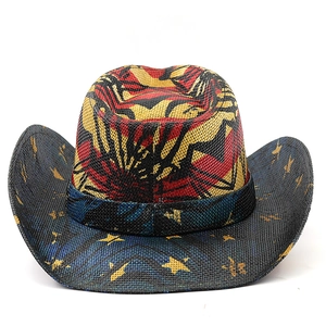Detail of western cowboy hat featuring red wavy patterns and yellow stars on the brim
