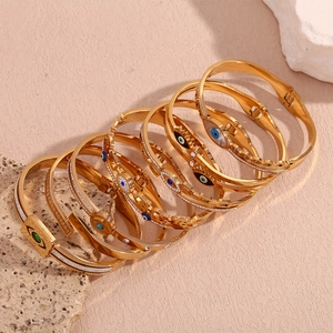 Close-up of 18K gold plated stainless steel bracelet with micro-pave evil eye charms