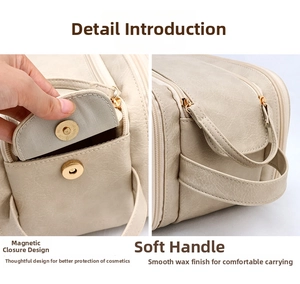 Detail of beige makeup bag showing magnetic snap closure and soft leather handle texture