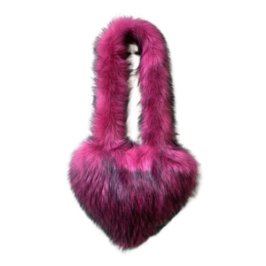 Detail of heart-shaped faux fur crossbody bag with vibrant magenta and black gradient texture