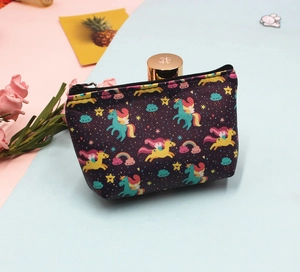 Detail of purple unicorn coin purse with rainbow patterns on pink and blue background