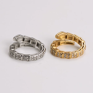 Macro detail of snake-shaped open rings with pavé cubic zirconia in gold and silver finish