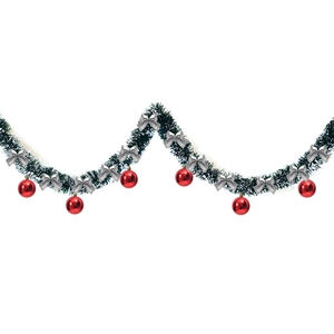 Detail of 2m green tinsel with snow tips, silver bows, and red ornaments for Christmas trees