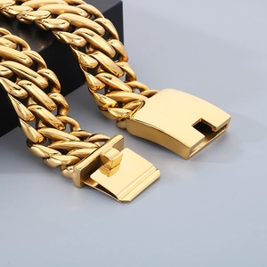 Close-up of gold stainless steel cuban curb bracelet with thick woven links and clasp