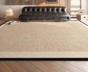 Detailed close-up of beige woven rug with 3D geometric texture and black border edges