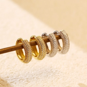 Close-up of gold and silver S925 sterling silver hoop earrings with micro-pave zircons