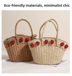 Detail of woven straw bags in brown and beige with crochet strawberry and pearl accents