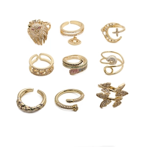 Detail of 9-piece gold bohemian ring set with evil eye and animal micro-pave charms