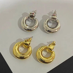 Minimalist 18K gold and silver chunky hoop earrings with round metallic backings