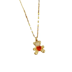 Gold teddy bear necklace with red heart zircon and shimmering crystal accents