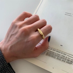 Minimalist irregular gold 925 sterling silver ring shown on a fashion magazine
