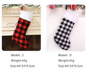 Detail view of red and black buffalo plaid Christmas stockings with size and weight info