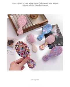 Detail view of colorful acetate massage hair combs with compact dimensions 14.1x4.8x0.8cm
