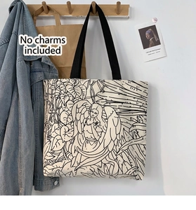 Detail of cream canvas tote bag with artistic black and white jungle angel illustration