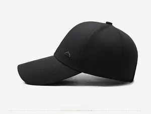 Side view of black baseball cap with curved brim and metallic mountain logo detail