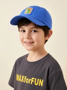 Close-up of cute cartoon dinosaur patch on bright blue kid's baseball sun hat