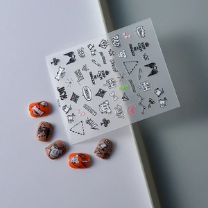 Detail of 5D black graffiti nail stickers with letters, hearts and devil wing motifs