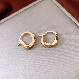 Detailed macro view of 18K gold plated irregular oval earrings with molten metal texture