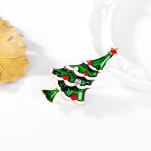Detailed view of enamel Christmas tree brooch with colorful rhinestones and gold plating