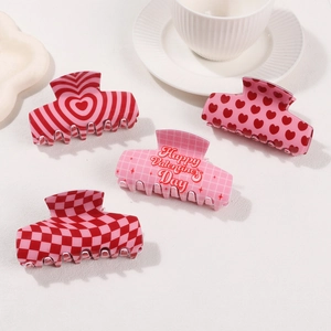 Set of four Valentine's Day hair claw clips with heart patterns and checkered designs