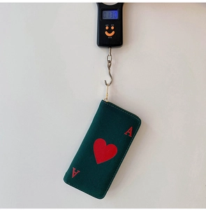 Detail view showing Ace of Hearts canvas clutch bag weighing 0.130kg on a digital scale