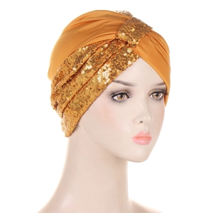 Detailed side view of golden sequin square turban hat on a mannequin head