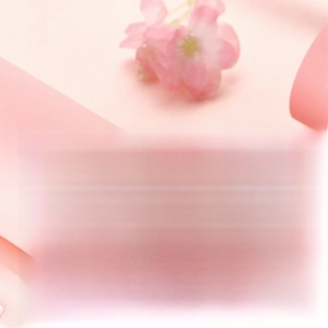 Macro shot of pearl necklace with pavé metal accents against a soft pink background