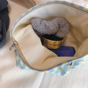 Blue and yellow plaid canvas makeup bag with zipper closure and spacious interior storage