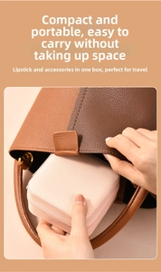 Pink portable travel jewelry box being placed in a handbag for compact storage