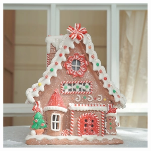 Detailed view of a glowing Christmas gingerbread house with white frosting and candy accents