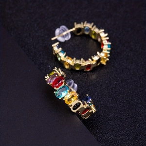 Detailed macro of vintage rainbow hoop earrings with colorful oval-cut gemstones
