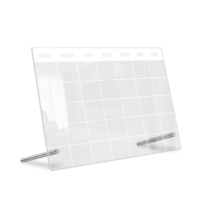 Macro detail of a transparent acrylic weekly planner with metal supports and white text